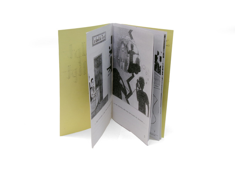 A detail of the previous zine. This photograph shows two pages of its interior, with indistinct text and drawings featured.