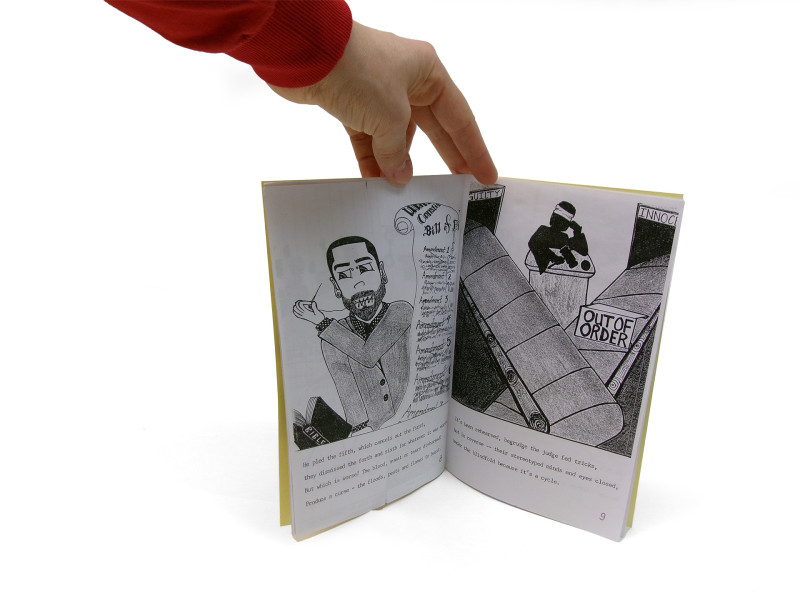 Another detail of the previous zine. This photograph shows two pages of its interior, with indistinct text and drawings featured.